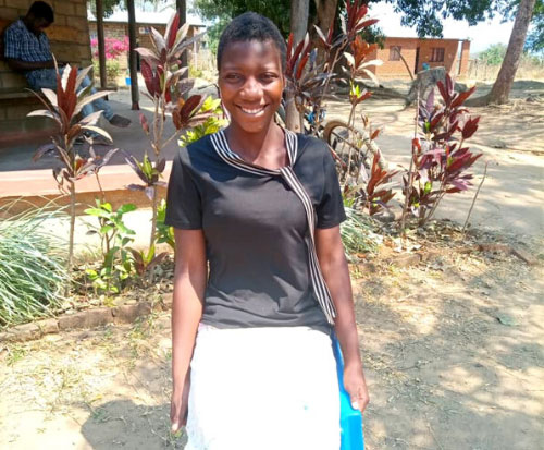 Kondwani wants to improve her English so attends adult literacy classes in Malawi