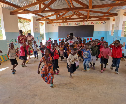 Preschool children dancing and play around at school in Malawi