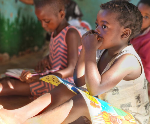 A child listens to the teacher at Reading Club in Malawi