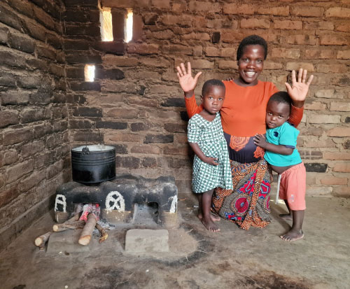 Aida is a happy mother as she can cook quicker on her cookstove in Malawi