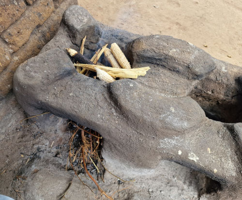 Cooking with maize cobs in Malawi