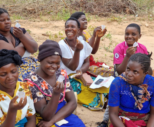 A group of women learn about menstrual cups in Malawi