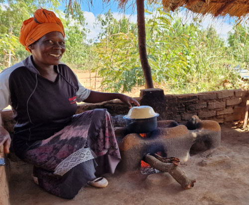 Charity is a happy Community Volunteer on the cookstove project in Malawi
