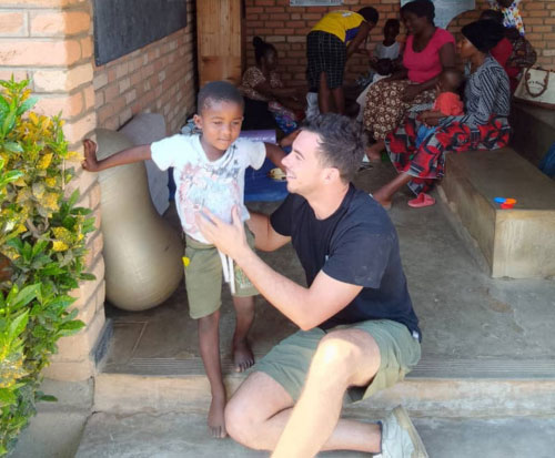 Volunteer Tommaso supporting clients on our Disabilities and Rehabilitation project in Malawi