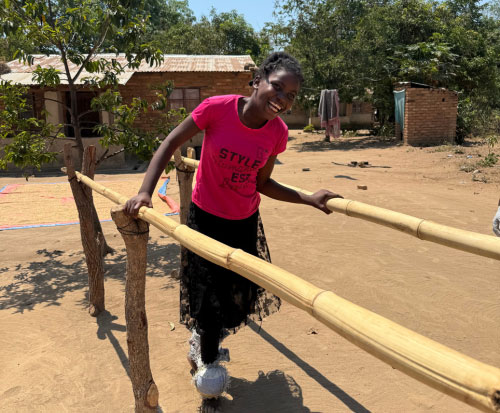 Fortune is using parallel bars to strengthen her leg muscles