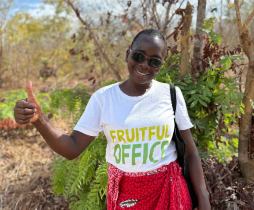 Catherine, Forest Conservation Coordinator giving a thumbs up next to protected trees