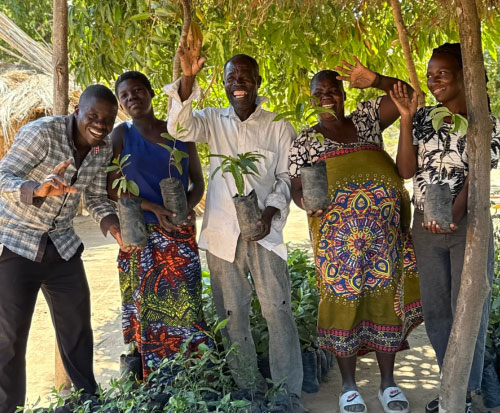 Growing the Future Club smiling with their fruit tree seedlings