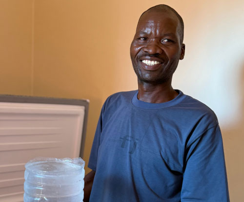 Chilimba Beach Village Committee member holding an ice block