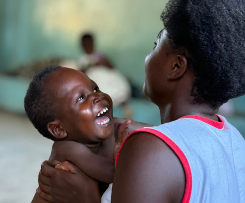 A client with his mother at a physiotherapy group in Malawi