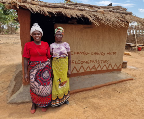 Jessie and her grandmother stand outside their kitchen