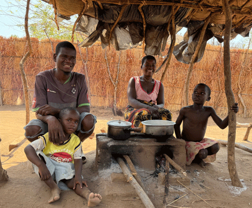 Chimwemwe and her family sat by their fuel efficient cookstoves