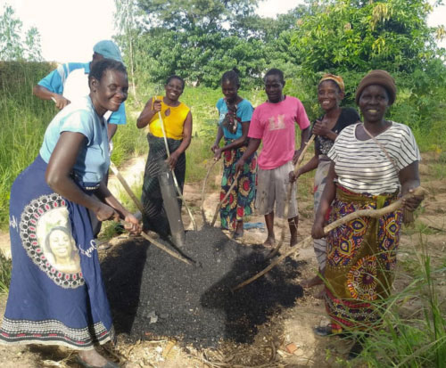 Group working on making biochar for their briquettes