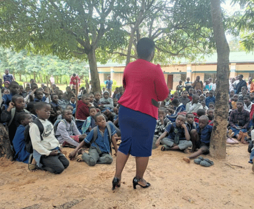 Loveness speaking to a school about disability awareness