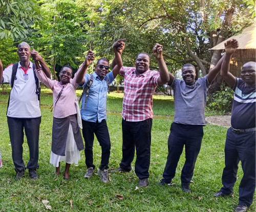 Maston and our Fish and Forest teams holding hands after training