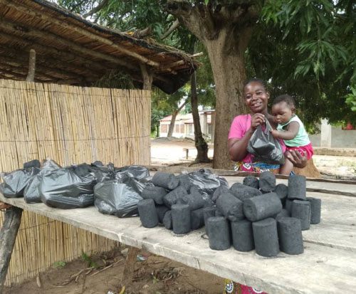Woman and her son selling their homemade briquettes