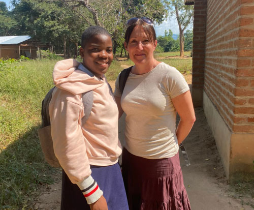 Claire with a school student in Malawi
