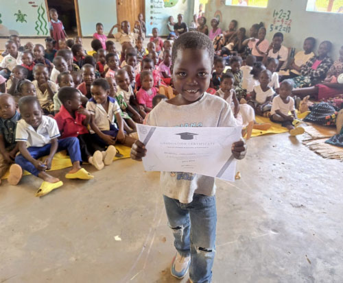 Preschool graduate with his certificate