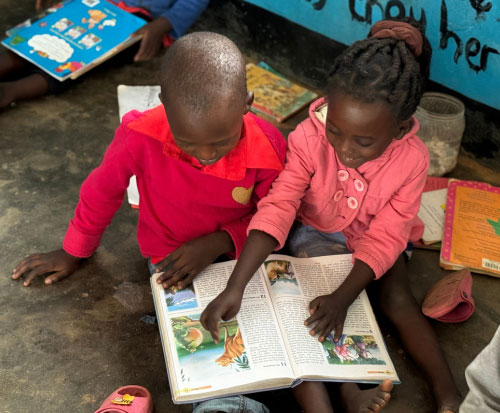 Reading a book at preschool in Malawi
