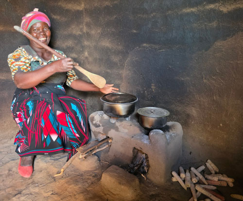 Aliness cooking on her cookstove